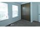 Cozy bedroom with carpeted floor and closet space, offers ample natural light through its windows at 9669 W Chatfield Ave # A, Littleton, CO 80128