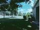 This is the front yard of a home with mature trees and a lush lawn, giving curb appeal at 9669 W Chatfield Ave # A, Littleton, CO 80128