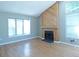 Bright living room features a fireplace with wood paneling and large windows for natural light at 9669 W Chatfield Ave # A, Littleton, CO 80128