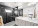 Modern bathroom featuring a glass-enclosed shower, double vanity, and sleek black-and-white design at 1581 King St, Denver, CO 80204
