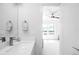 Bathroom with modern sink and mirror, next to a bedroom with a ceiling fan at 1581 King St, Denver, CO 80204