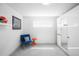Serene bedroom features a blue chair, orange table, and a shelf adorned with football memorabilia at 1581 King St, Denver, CO 80204