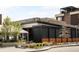 Exterior of a building with a modern design, featuring a patio area with tables and chairs at 1581 King St, Denver, CO 80204