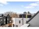 Scenic rooftop view overlooking modern townhomes, mountains, and a vibrant cityscape at 1581 King St, Denver, CO 80204