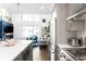 Open-concept kitchen flows into living area with fireplace and large windows at 1581 King St, Denver, CO 80204