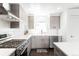 Stylish kitchen boasts stainless steel appliances, sleek cabinetry, and white countertops and backsplash at 1581 King St, Denver, CO 80204