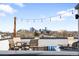 Rooftop deck features lounge seating, a dining table, and city views at 1581 King St, Denver, CO 80204