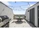 Outdoor living area with dining table, chairs, and barbecue grill at 1581 King St, Denver, CO 80204