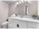 This bright bathroom features a white vanity with ample storage and a decorative mirror at 16359 W 10Th Ave # T1, Golden, CO 80401
