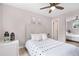 This bedroom features a neutral color palette, a ceiling fan, and a mirrored closet at 16359 W 10Th Ave # T1, Golden, CO 80401