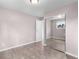 This empty bedroom features wood-look flooring, fresh paint, and a mirrored closet at 16359 W 10Th Ave # T1, Golden, CO 80401