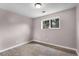 This empty bedroom features wood-look flooring, fresh paint, and a window at 16359 W 10Th Ave # T1, Golden, CO 80401