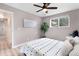 This bedroom features a neutral color palette, a ceiling fan, and a large window at 16359 W 10Th Ave # T1, Golden, CO 80401