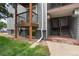 View of the building exterior with a balcony, stairs, and landscaped lawn at 16359 W 10Th Ave # T1, Golden, CO 80401