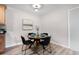 Bright dining area featuring a round table, modern seating, and light-colored walls and flooring at 16359 W 10Th Ave # T1, Golden, CO 80401