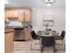 Dining area with a round table and chairs located next to the kitchen with bright wood cabinets at 16359 W 10Th Ave # T1, Golden, CO 80401