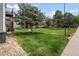 Apartment building featuring lush landscaping, mature trees, and well-maintained lawn at 16359 W 10Th Ave # T1, Golden, CO 80401