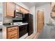 Updated kitchen with stainless steel appliances, white cabinets, and black countertop at 16359 W 10Th Ave # T1, Golden, CO 80401