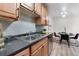 Kitchen featuring stainless steel sink, light wood cabinets, and dining area at 16359 W 10Th Ave # T1, Golden, CO 80401