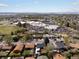 An aerial view shows a sprawling neighborhood with mature trees and a school or community center at 2433 E 90Th Ave, Thornton, CO 80229