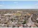 Aerial view of a suburban neighborhood with tree-lined streets, well-maintained homes, and green spaces at 2433 E 90Th Ave, Thornton, CO 80229