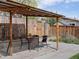 Backyard features a patio and dining area, along with a wood fence at 2433 E 90Th Ave, Thornton, CO 80229