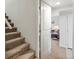 Basement entryway, leading to a finished living space with carpeted stairs, and white painted walls at 2433 E 90Th Ave, Thornton, CO 80229
