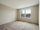 Bright bedroom featuring neutral carpet and a large window offers a tranquil retreat at 2433 E 90Th Ave, Thornton, CO 80229
