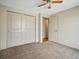 Inviting bedroom with ceiling fan and neutral carpet offers a relaxing ambiance and closet space at 2433 E 90Th Ave, Thornton, CO 80229