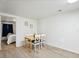 Bright dining area with wooden table and chairs, seamlessly connected to a serene bedroom, offering comfort at 2433 E 90Th Ave, Thornton, CO 80229