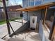 Basement entrance featuring concrete stairs, a sturdy handrail, and a protective overhead covering at 2433 E 90Th Ave, Thornton, CO 80229