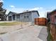 Charming single-story home with a garage, front door, and a wooden gate leading to the backyard at 2433 E 90Th Ave, Thornton, CO 80229