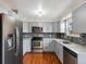 Updated kitchen with stainless steel appliances, gray cabinets, and tile backsplash offers style and functionality at 2433 E 90Th Ave, Thornton, CO 80229