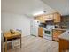 Functional kitchen area with wooden cabinets, white appliances, and ample space for dining and meal preparation at 2433 E 90Th Ave, Thornton, CO 80229