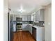 Updated kitchen with stainless steel appliances, gray cabinets, and tile backsplash offers style and functionality at 2433 E 90Th Ave, Thornton, CO 80229