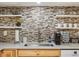 Kitchen area featuring stylish backsplash, open shelving, and sleek stainless steel appliances, perfect for modern living at 2433 E 90Th Ave, Thornton, CO 80229