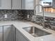 Stylish kitchen sink with modern faucet, quartz countertops, and chic backsplash tiles at 2433 E 90Th Ave, Thornton, CO 80229