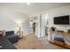 Cozy living room featuring plush carpeting, modern furnishings, and an open layout flowing into the kitchen at 2433 E 90Th Ave, Thornton, CO 80229