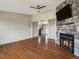 Comfortable living room showcasing a stone fireplace, hardwood floors, and easy access to other rooms at 2433 E 90Th Ave, Thornton, CO 80229