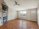 Bright living room featuring hardwood floors, a stone fireplace, and ample natural light at 2433 E 90Th Ave, Thornton, CO 80229
