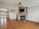 Inviting living room with hardwood floors, stone fireplace, and open access to adjacent spaces at 2433 E 90Th Ave, Thornton, CO 80229