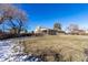 Spacious backyard with a large lawn area and mature trees at 7770 Simms St, Arvada, CO 80005