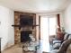 Living room with stone fireplace, hardwood floors, and glass coffee table at 14413 E Jewell Ave # 201, Aurora, CO 80012