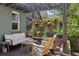 Inviting back porch with a seating area under a pergola covered in greenery and decorative lighting at 2445 N Franklin St, Denver, CO 80205