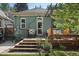 Charming backyard featuring a wooden deck, a dining table, and lush landscaping at 2445 N Franklin St, Denver, CO 80205