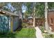 Serene backyard featuring a shed, mature trees, and a stone pathway, creating a private outdoor oasis at 2445 N Franklin St, Denver, CO 80205