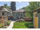 Backyard featuring a deck, shed, and landscaped lawn area for relaxing and entertaining at 2445 N Franklin St, Denver, CO 80205