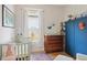 Charming Bedroom featuring a crib, a wooden dresser, and a blue armoire with an interesting nautical theme at 2445 N Franklin St, Denver, CO 80205