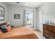Cozy bedroom with hardwood floors, natural light and a comfortable bed with colorful pillows at 2445 N Franklin St, Denver, CO 80205