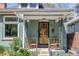 Inviting front porch featuring decorative ironwork, brick accents, and comfortable seating at 2445 N Franklin St, Denver, CO 80205